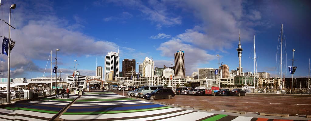 Auckland skyline viewed from the Viaduct Basin waterfront, reflecting New Zealand's economic recovery and rising borrowing costs in 2026