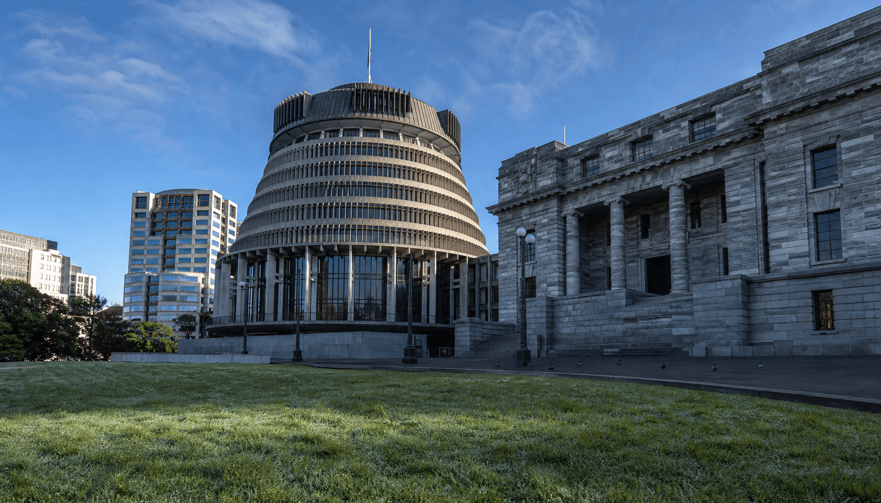 The Beehive executive wing in Wellington on a clear morning, shot from the lawn forecourt at low angle