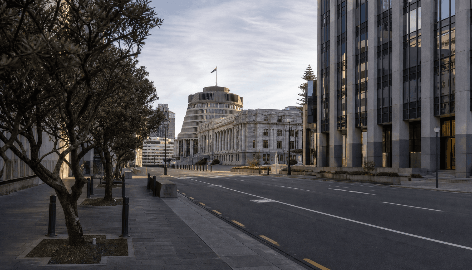 Wellington's Lambton Quay financial precinct with the Beehive visible in the background on a clear afternoon