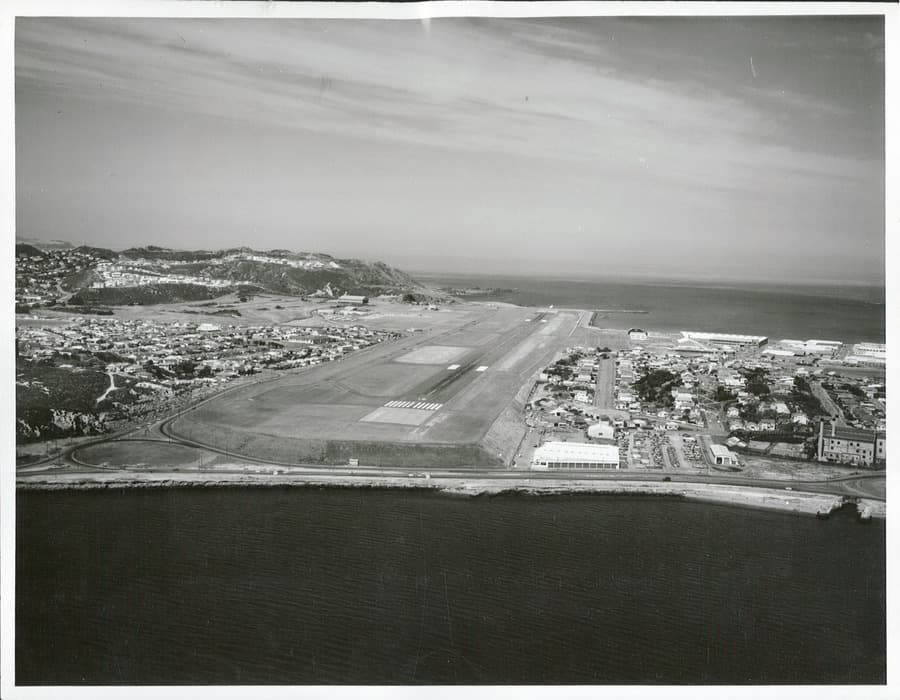 Aerial view of Wellington International Airport showing the runway extending toward the southern coastline